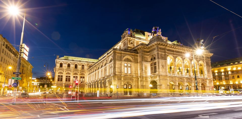 Vienna: Panoramic Night Tour by Bus - Belvedere Palace glowing in the dark